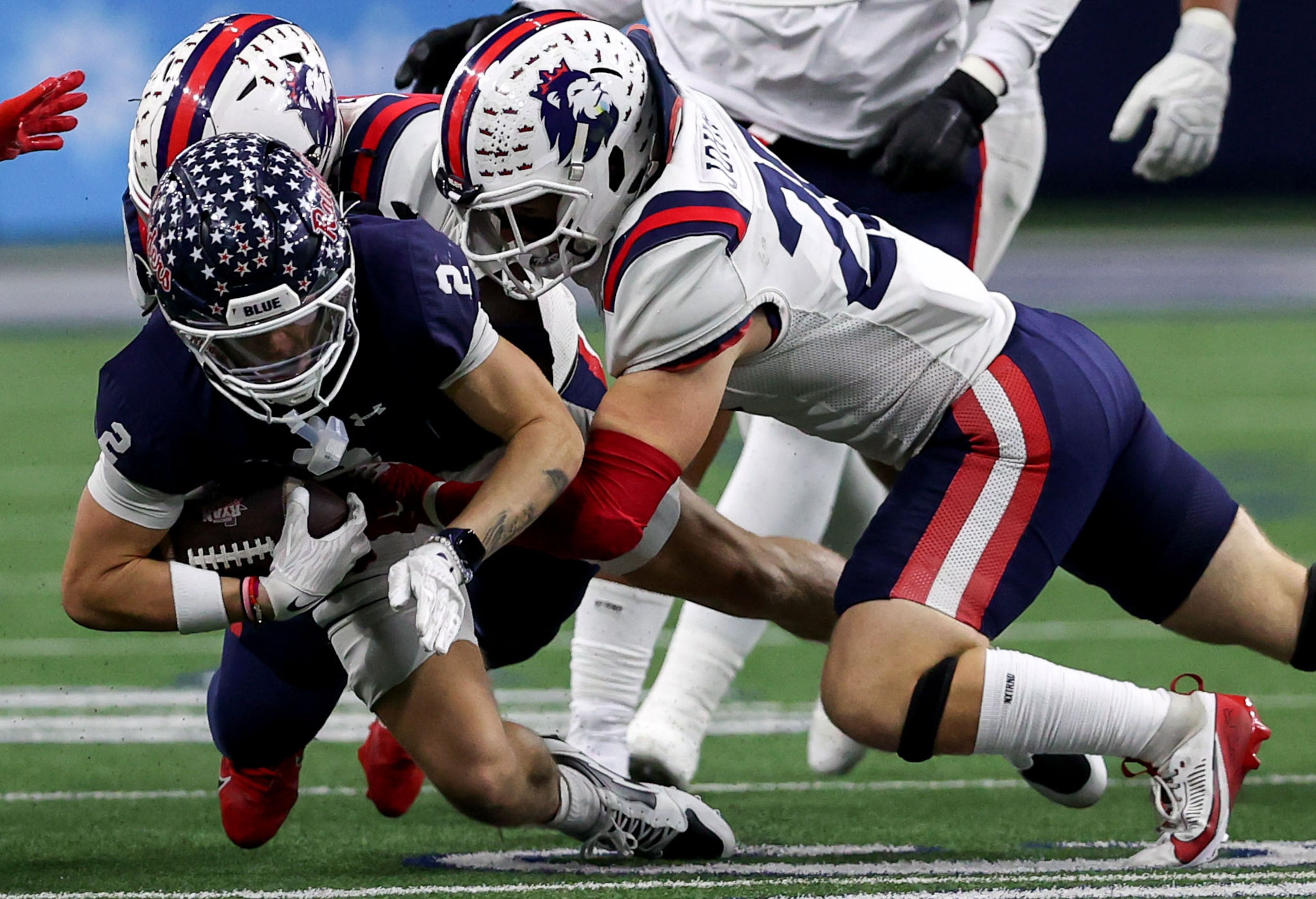 Denton Ryan wide receiver Braeden Mussett (2) is brought down for a short gain by Richland...