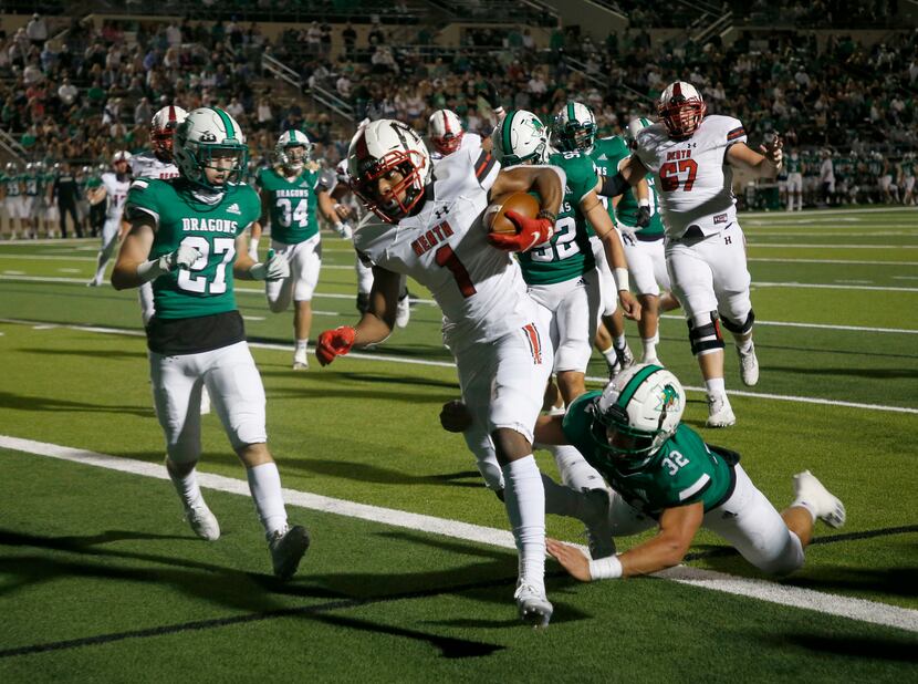 Rockwall Heath player Jay Fair (1) scores a touchdown in front of Southlake’s Mason Grawe...