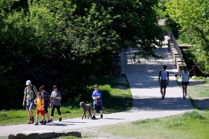 People make their way along the trail at Arbor Hills Nature Preserve, a 200-acre park in...