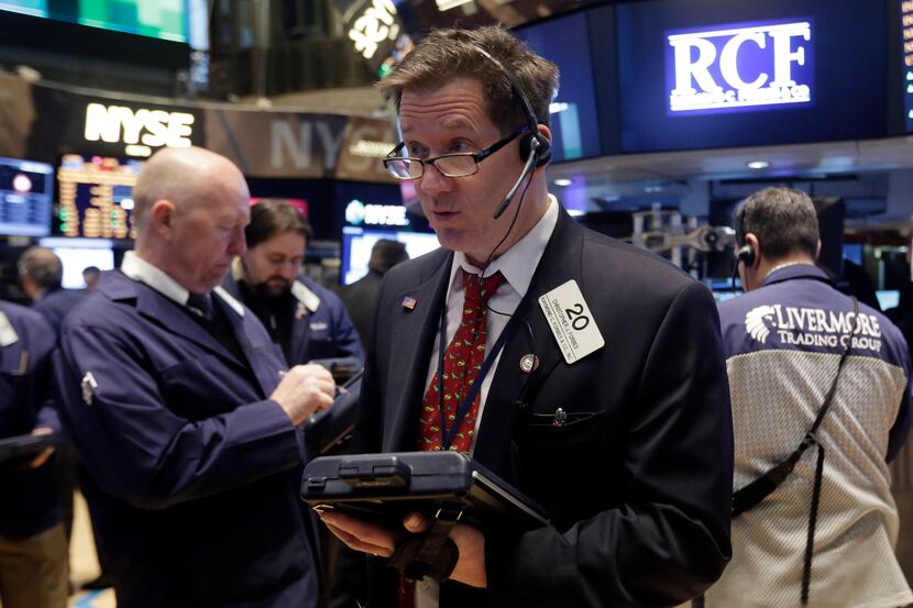 FILE - In this Wednesday, Feb. 26, 2014, file photo, Trader Christopher Forbes, center,...