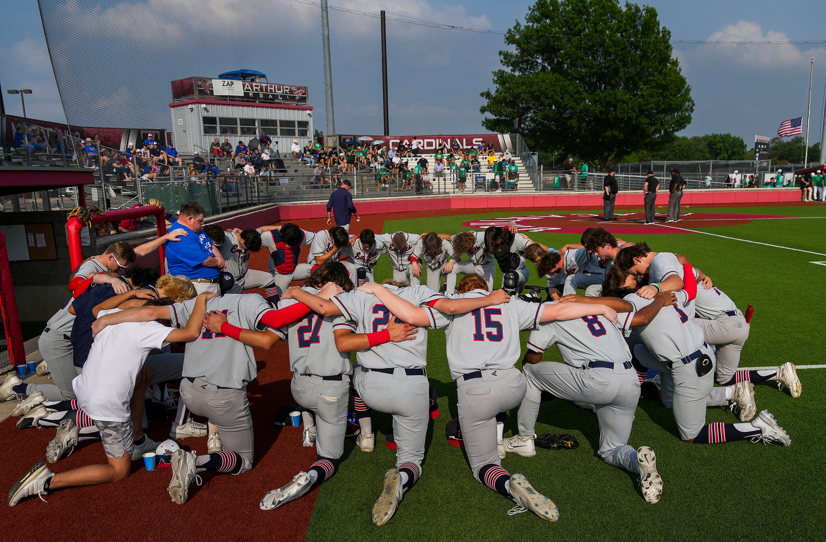 Allen players circle in prayer before Game 1 of a Class 6A area round high school baseball...