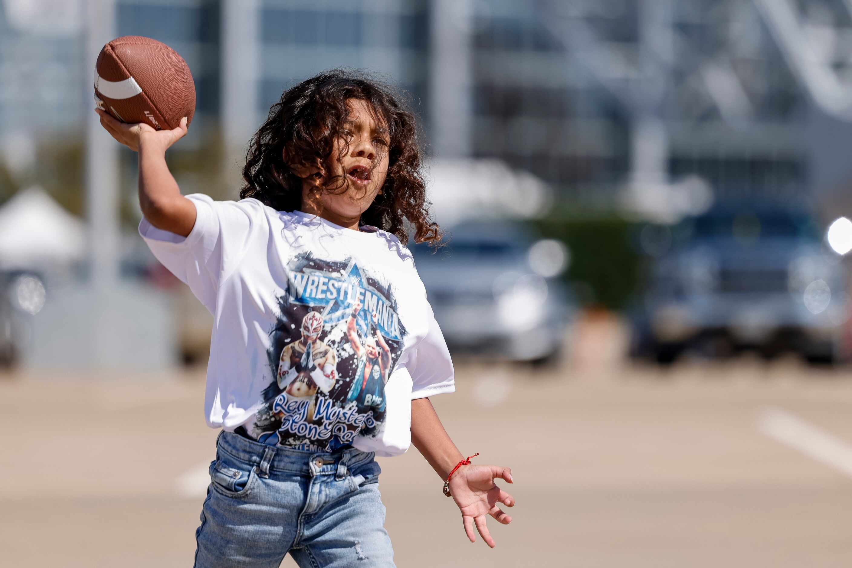 Jet Salazar, 7, throws a football with his dad before WrestleMania 38 at AT&T Stadium in...