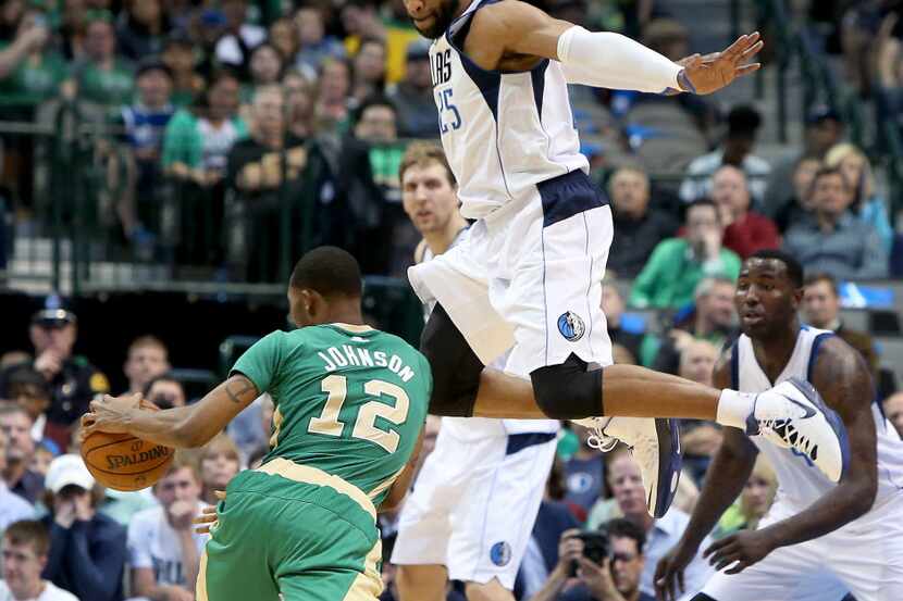 Dallas Mavericks guard Vince Carter (25) flies past Boston Celtics forward Chris Johnson...