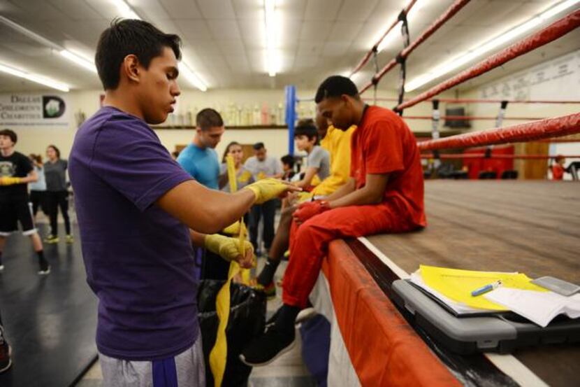 Hector Trujillo, 19, tapes up his hands before boxing practice.