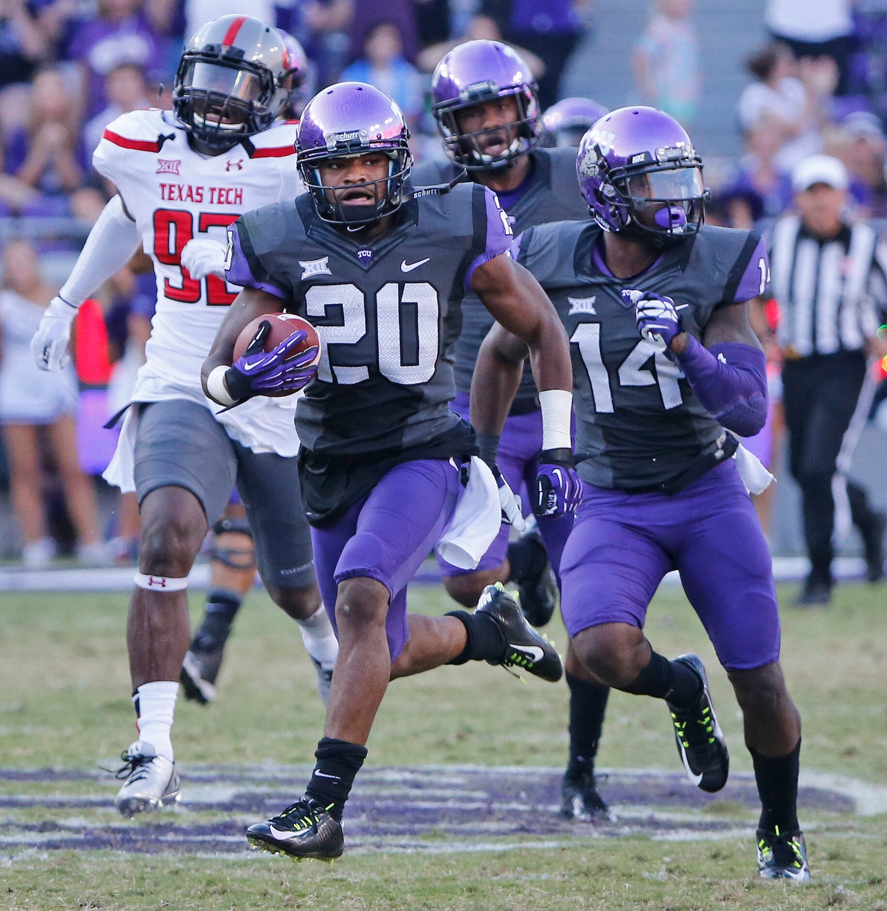 TCU receiver Deante' Gray (20) has an escort of teammates on a long touchdown run in the...