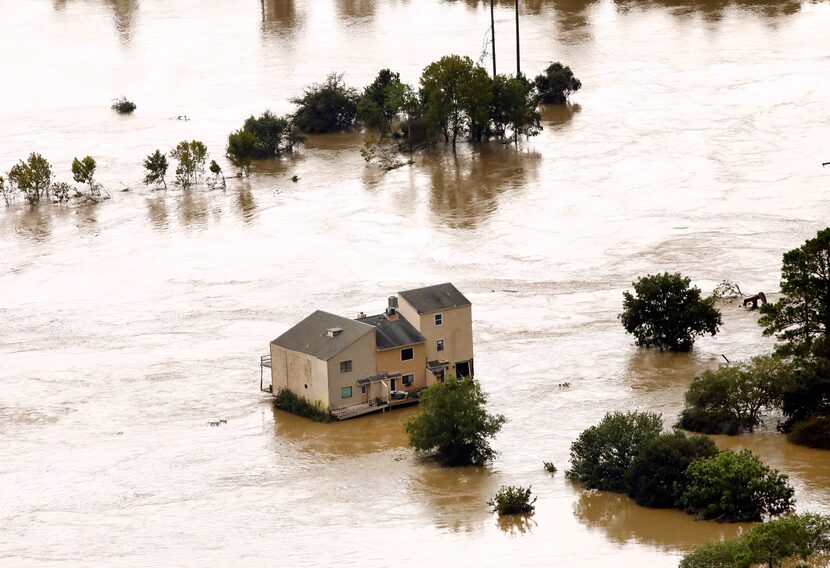 The River View Townhomes are surrounded by the overflowing San Jacinto River in Kingwood,...