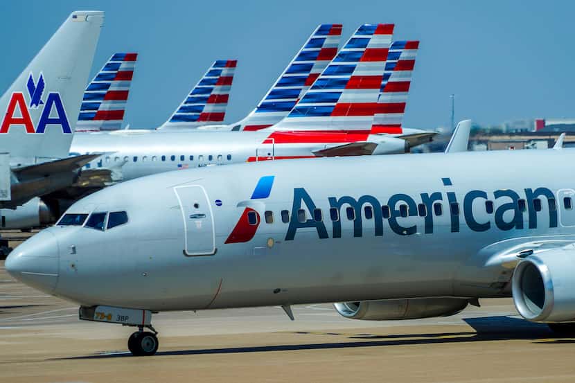 An American Airlines plane taxis to the gates of Terminal C at DFW Airport on Sunday, July...