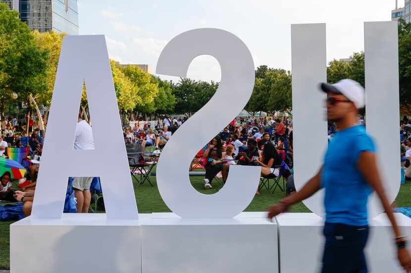 People gather during an Independence Day Celebration on July 2, 2022 at Klyde Warren Park in...