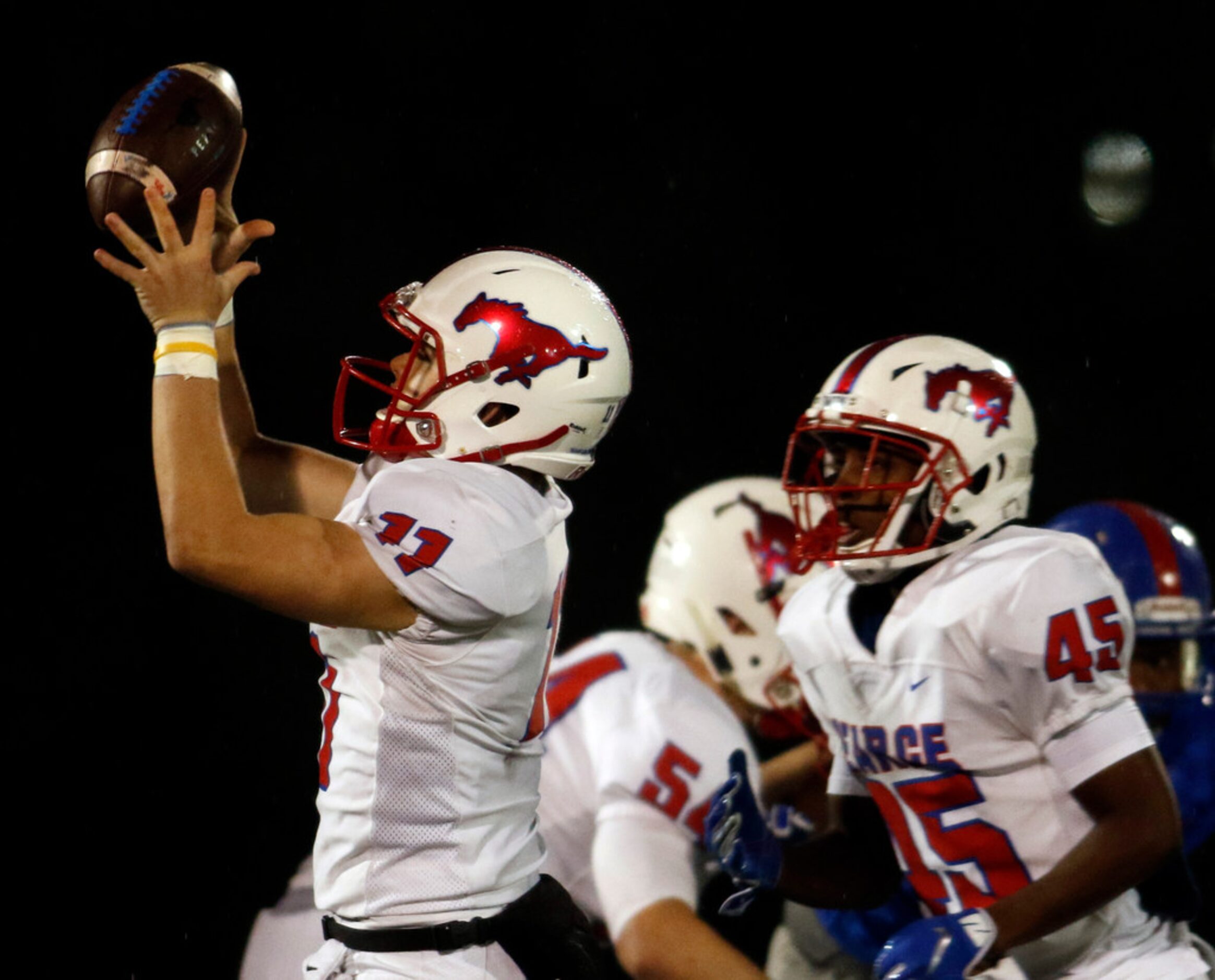 Richardson Pearce quarterback Bo Brewer (11) reaches to pull in a high snap from center...