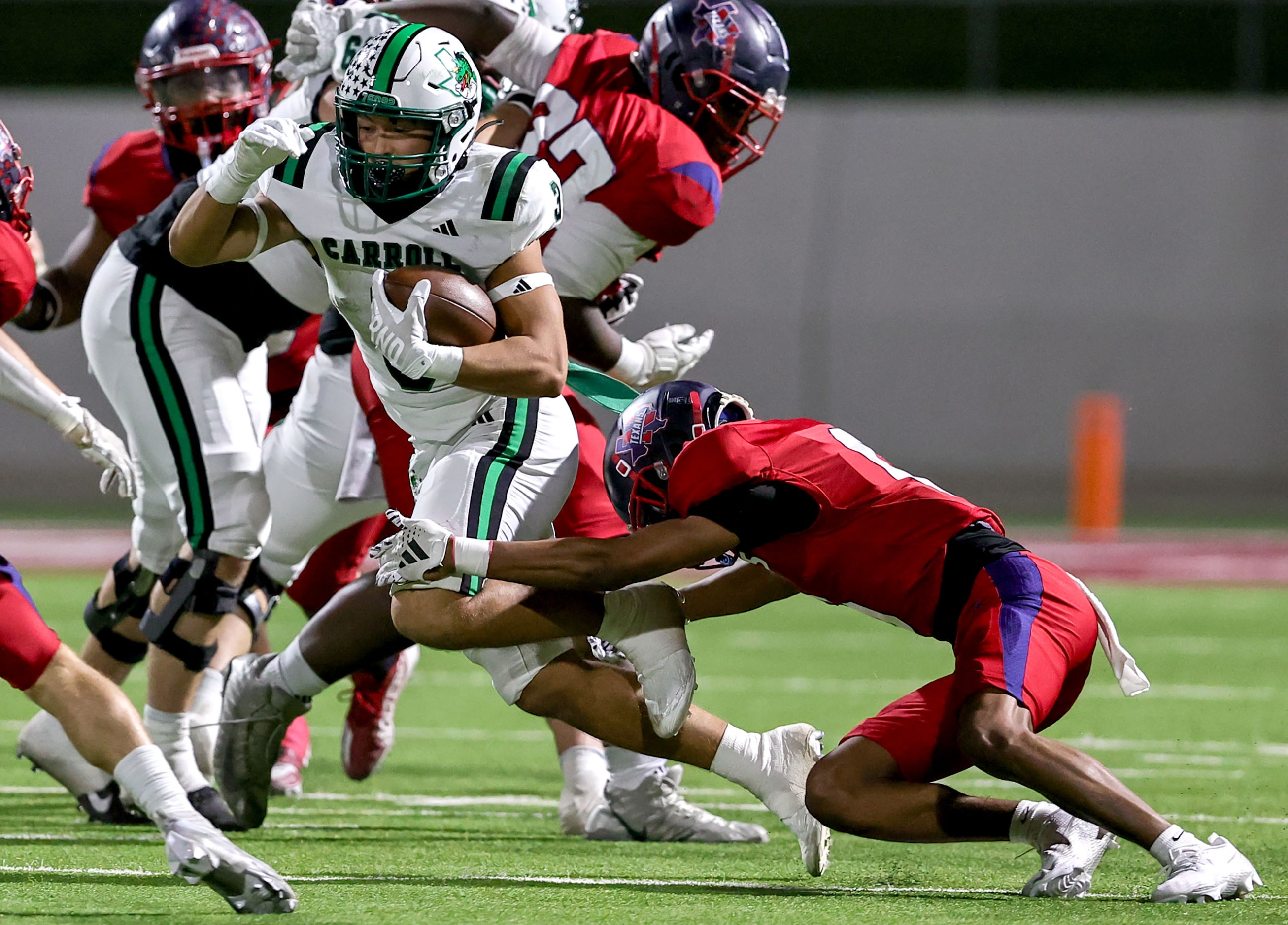 Southlake Carroll running back Davis Penn (3) finds a small hole to run as he is brought...