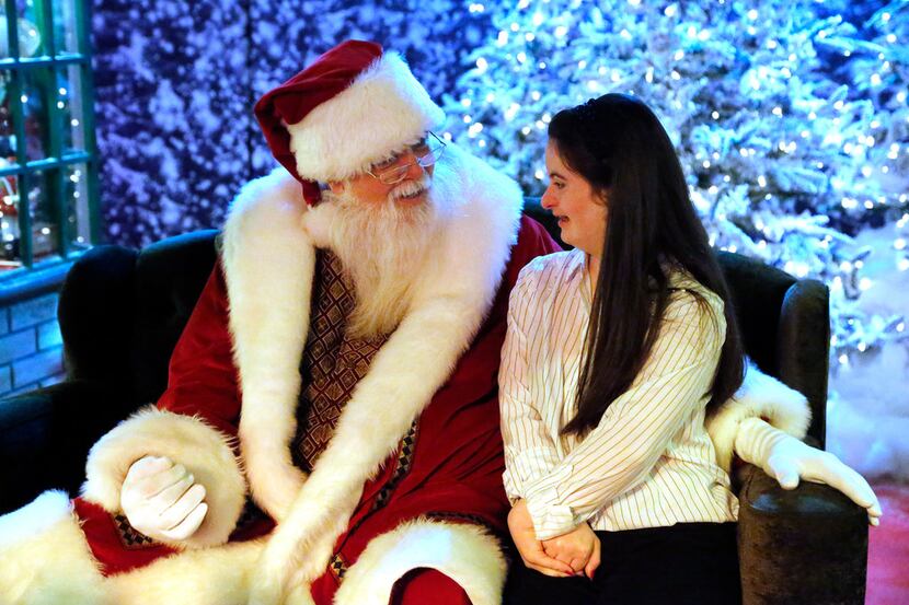 Sarah Boyles (right), 18, of Plano, poses for a photo with with Santa at The Galleria in...