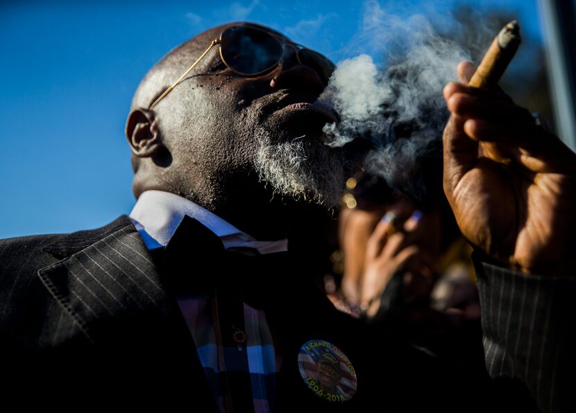 Brian Gregg puffs on a cigar in honor of Richard Overton at the Texas State Cemetery....