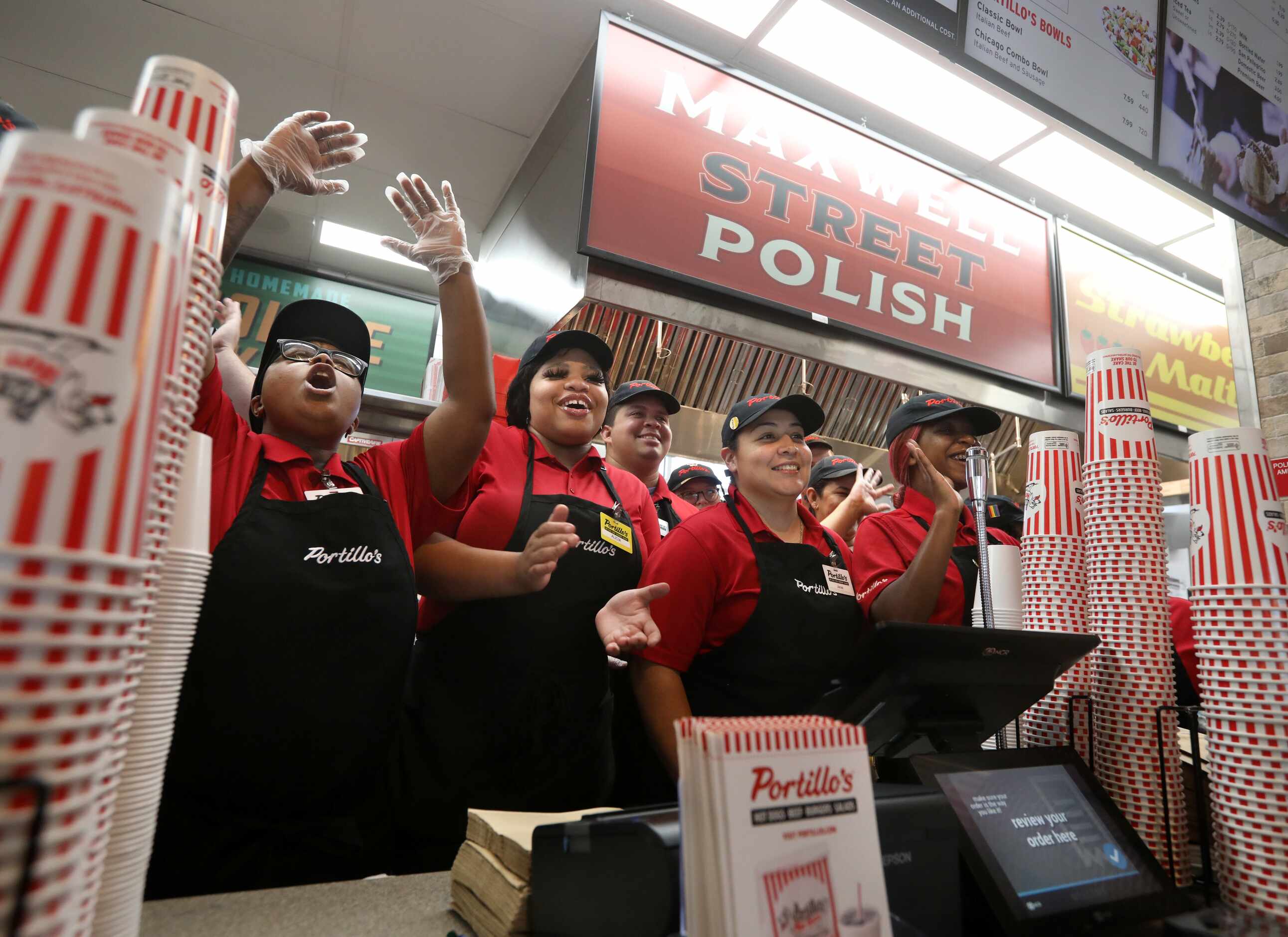 Employees cheer during the grand opening of Portillo's in Allen.