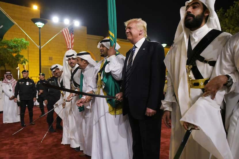 US President Donald Trump joins dancers with swords at a welcome ceremony ahead of a banquet...