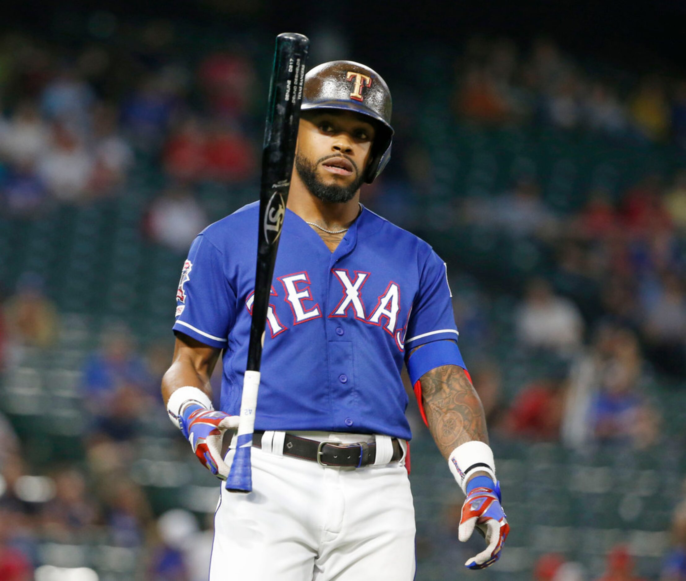 Texas Rangers' Delino DeShields (3) flips his bat after making a fly out against the Los...