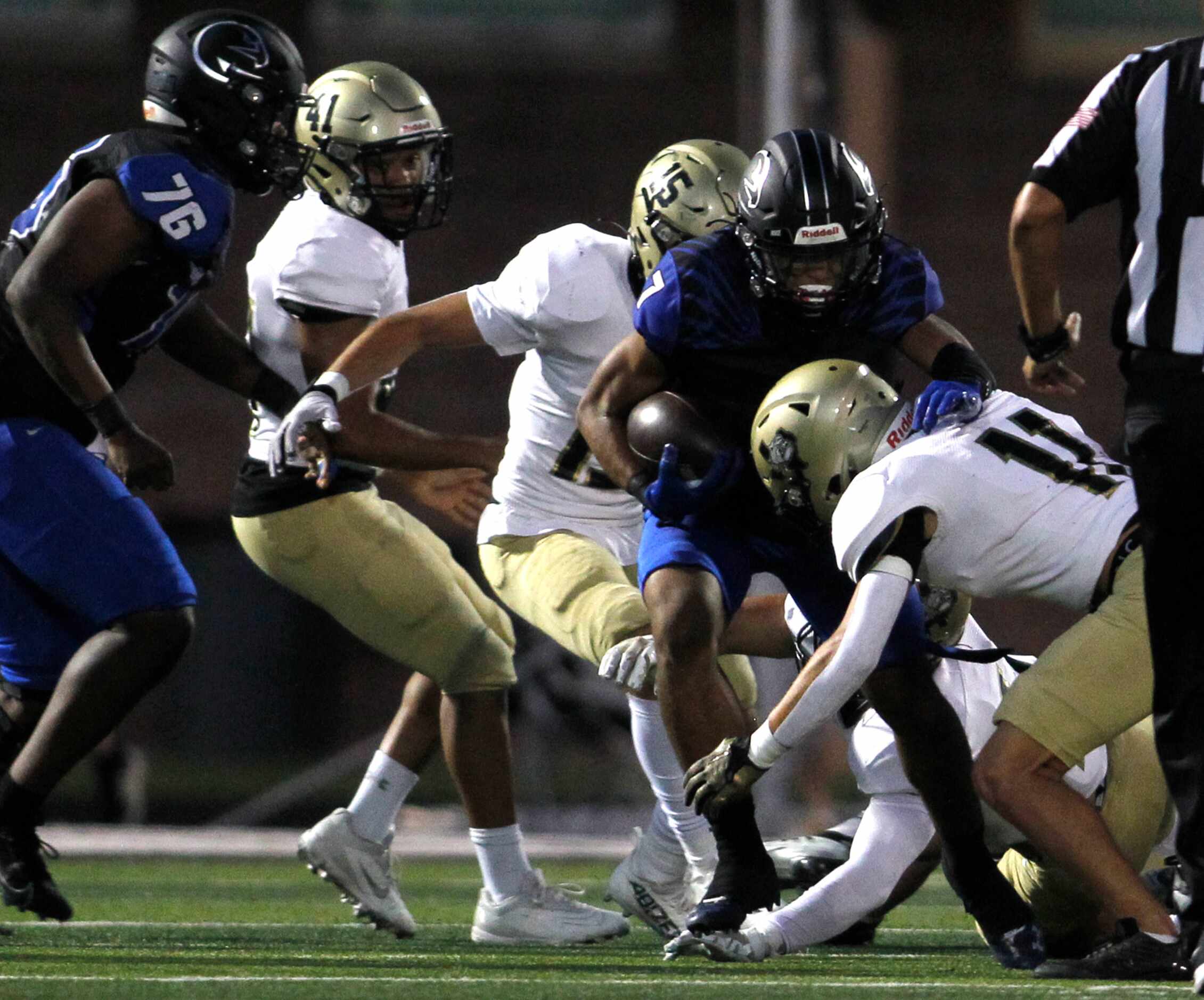 North Forney's Kellen Sanders (7) rushes for a short gain as he is sandwiched defensively by...