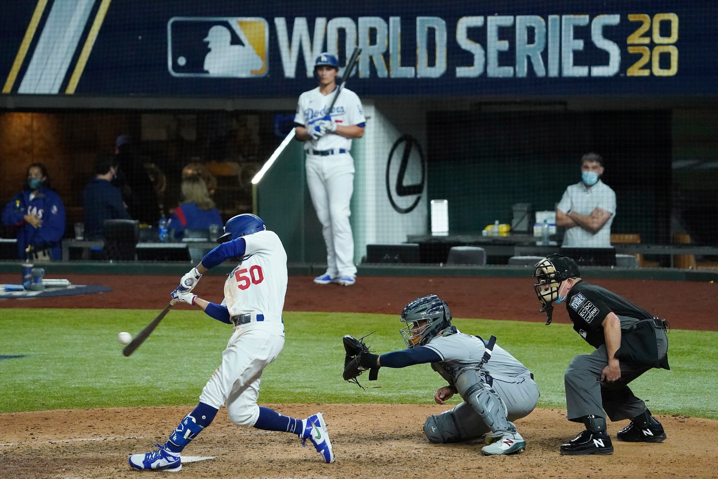 Los Angeles Dodgers right fielder Mookie Betts hits a solo home run during the eighth inning...