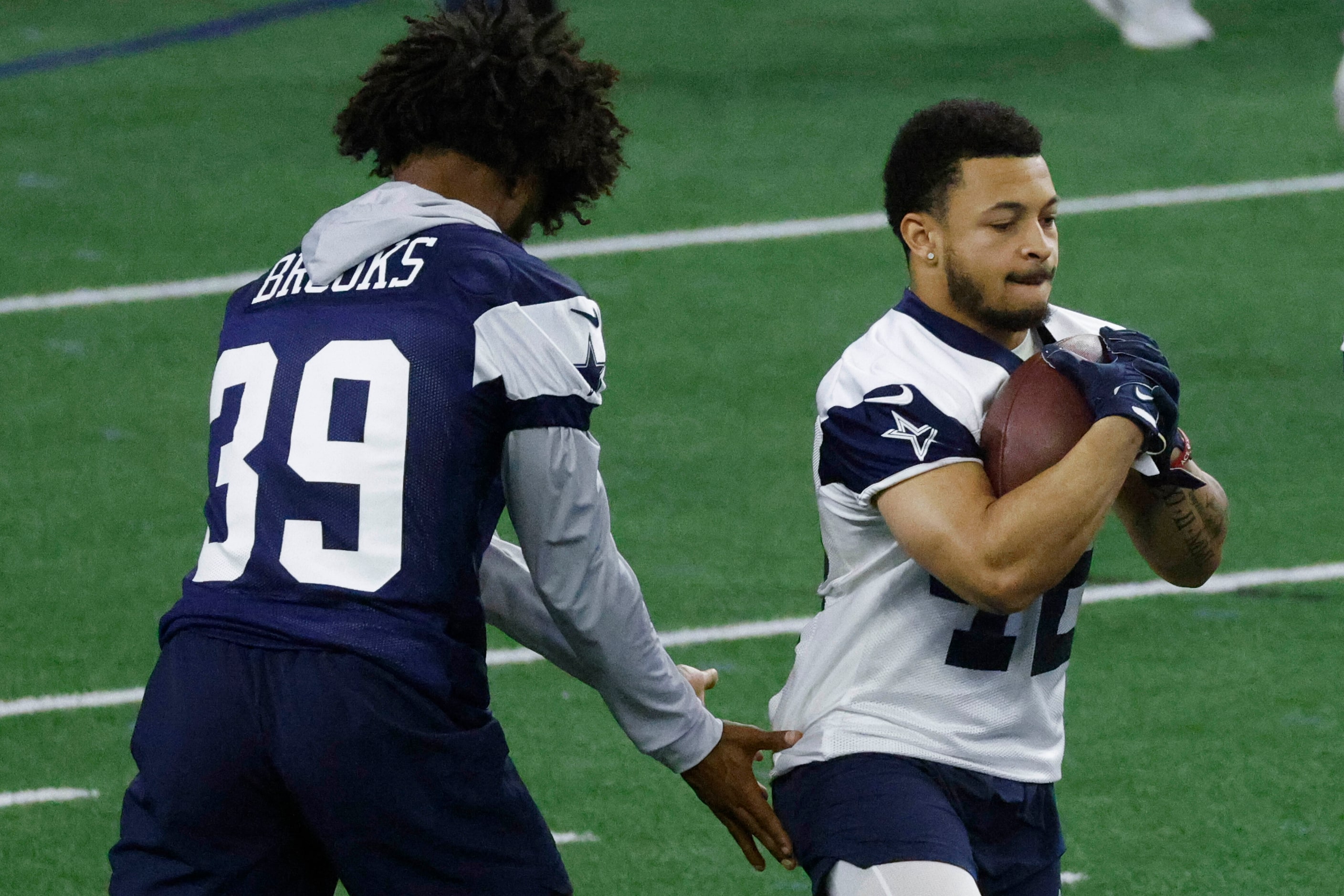 Dallas Cowboys running back Deuce Vaughn (right) practices during OTA practice on Thursday,...