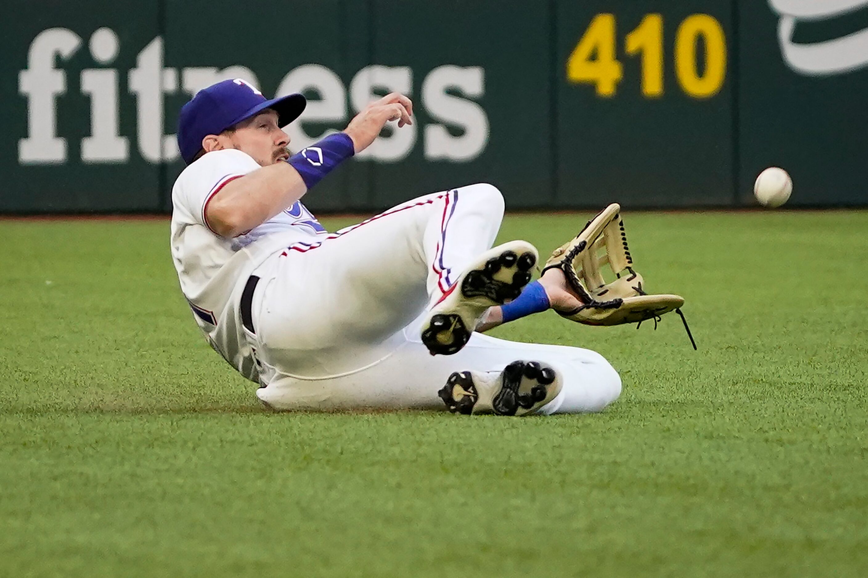 Texas Rangers left fielder David Dahl can’t make a sliding catch on a ball off the bat of...