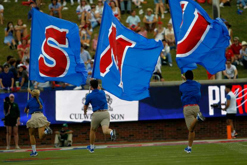 SMU spirit group members race across the field following a first half scoring drive in their...