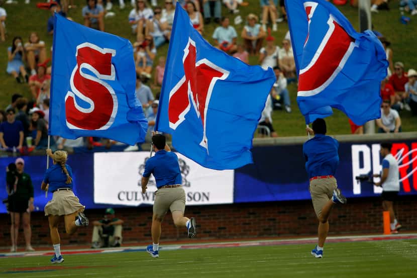 SMU spirit group members race across the field following a first half scoring drive in their...