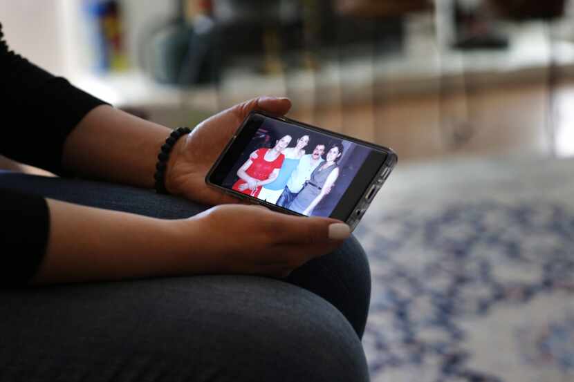 Navaz Ebrahim looks at a photograph of her family at her home in Dallas, TX, on Feb. 14, 2020.