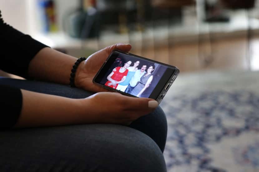 Navaz Ebrahim looks at a photograph of her family at her home in Dallas, TX, on Feb. 14, 2020.