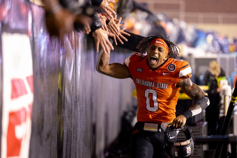 Oklahoma State running back Ollie Gordon II (0) celebrates with fans after the team's NCAA...