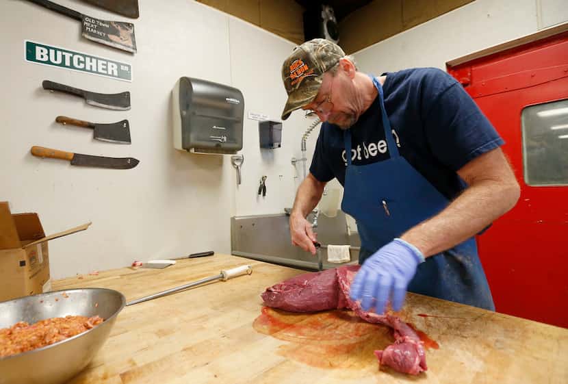 Owner Shawn Knowles cuts eye of round while he shows how to make jerky at his store Old Town...