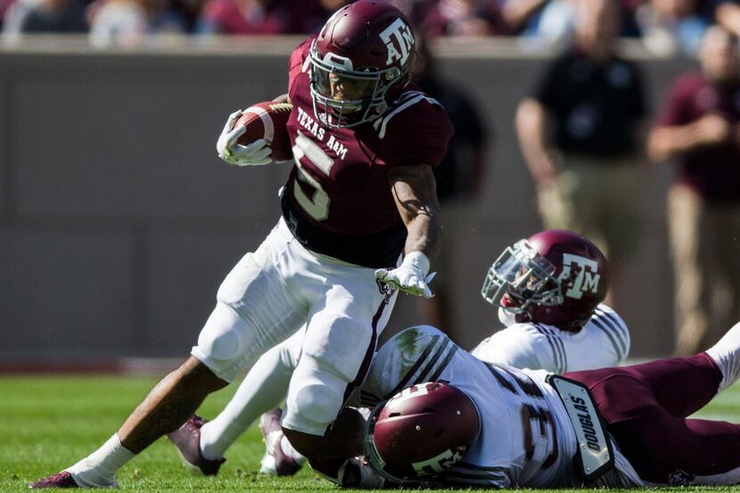 Texas A&M Aggies running back Trayveon Williams (5) is tackled by Texas A&M Aggies...