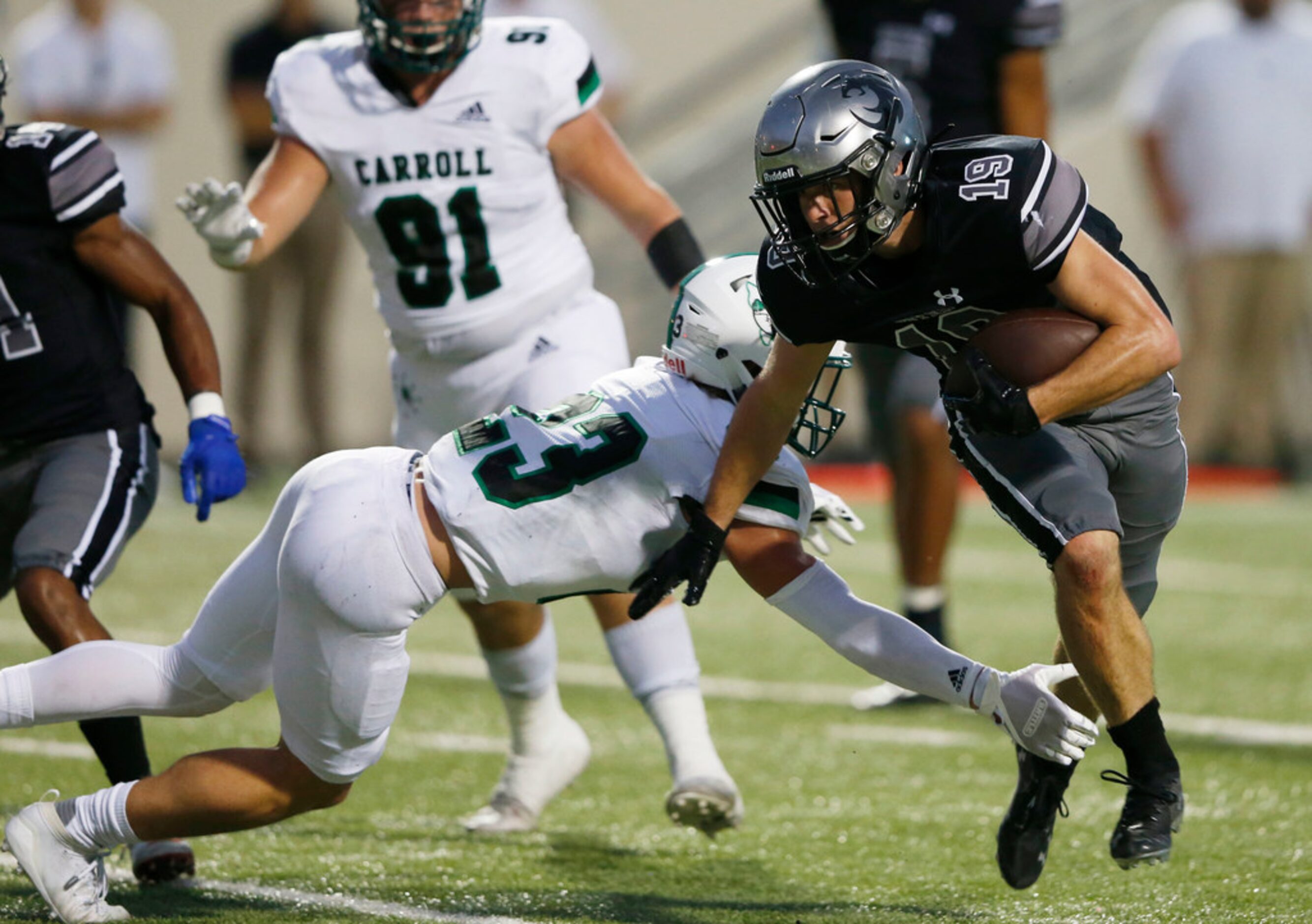 Denton Guyer's Seth Meador (19) breaks away from Southlake Carroll's Beck Para (23) for a...