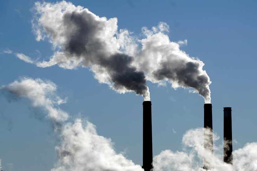 FILE - Steam is emitted from smoke stacks at a coal-fired power plant Nov. 17, 2021, in...