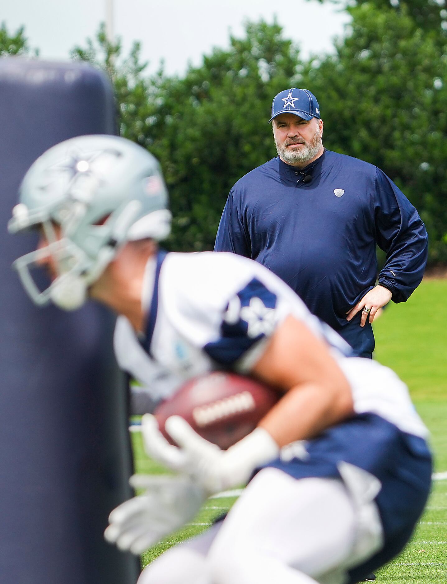 Dallas Cowboys head coach Mike McCarthy watches his team run drills during a minicamp...