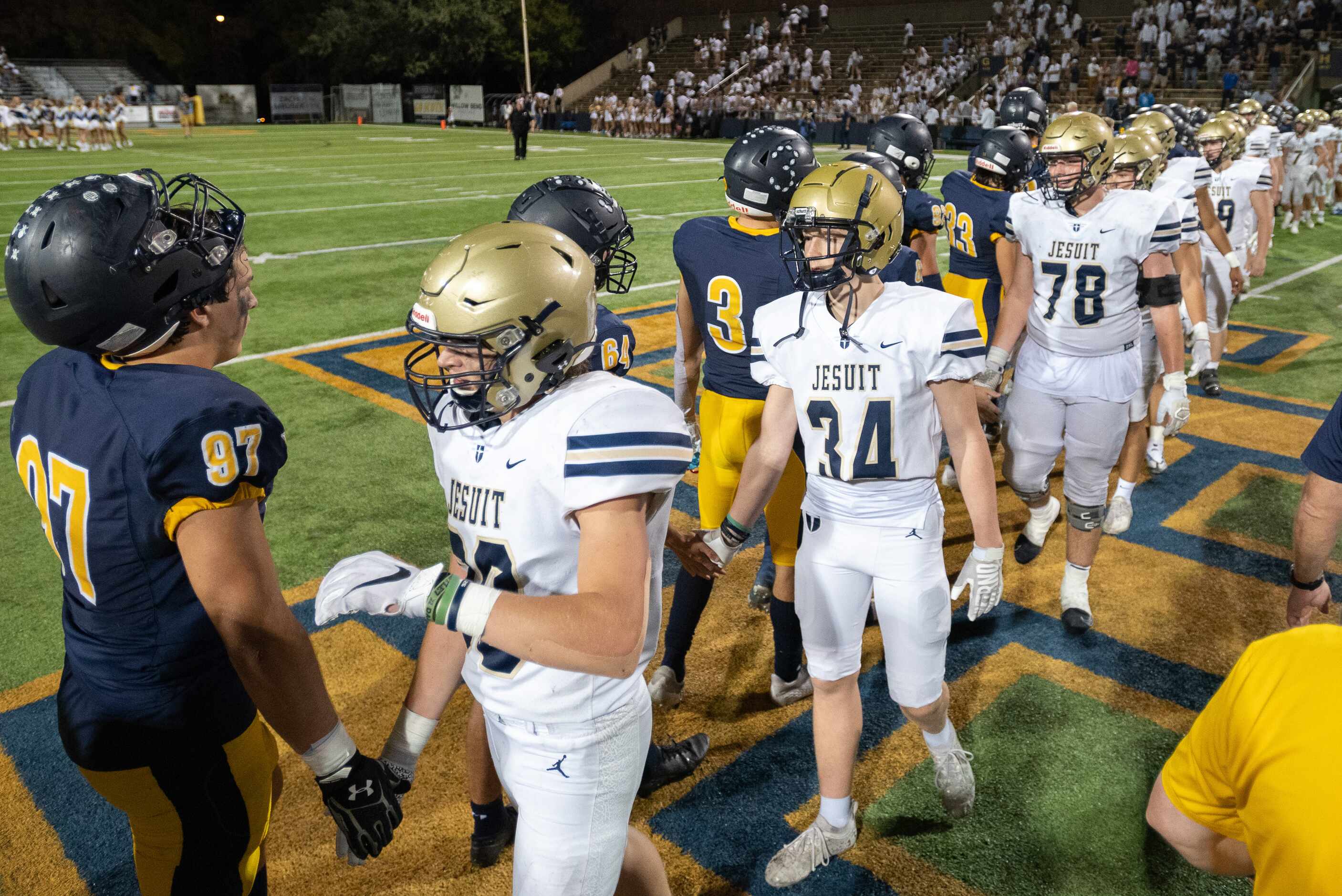 Jesuit and Highland Park football players congratulate each other on a good game as HP...