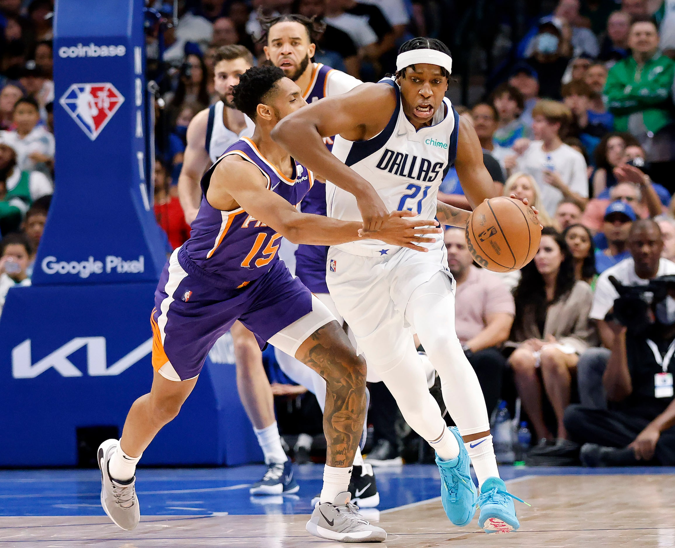 Dallas Mavericks guard Frank Ntilikina (21) is fouled by Phoenix Suns guard Cameron Payne...