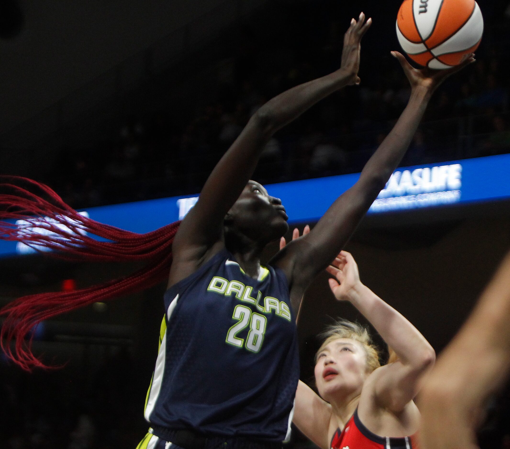 Dallas Wings forward Awak Kuier (28) goes up against Washington Mystics guard Li Meng (3)...