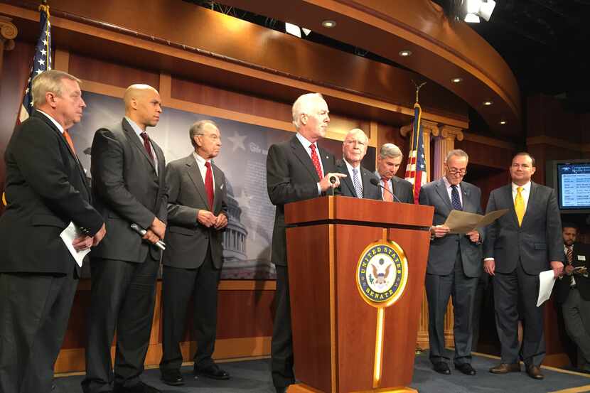  Sen. John Cornyn, at lectern, speaks to reporters to announce a bipartisan criminal justice...
