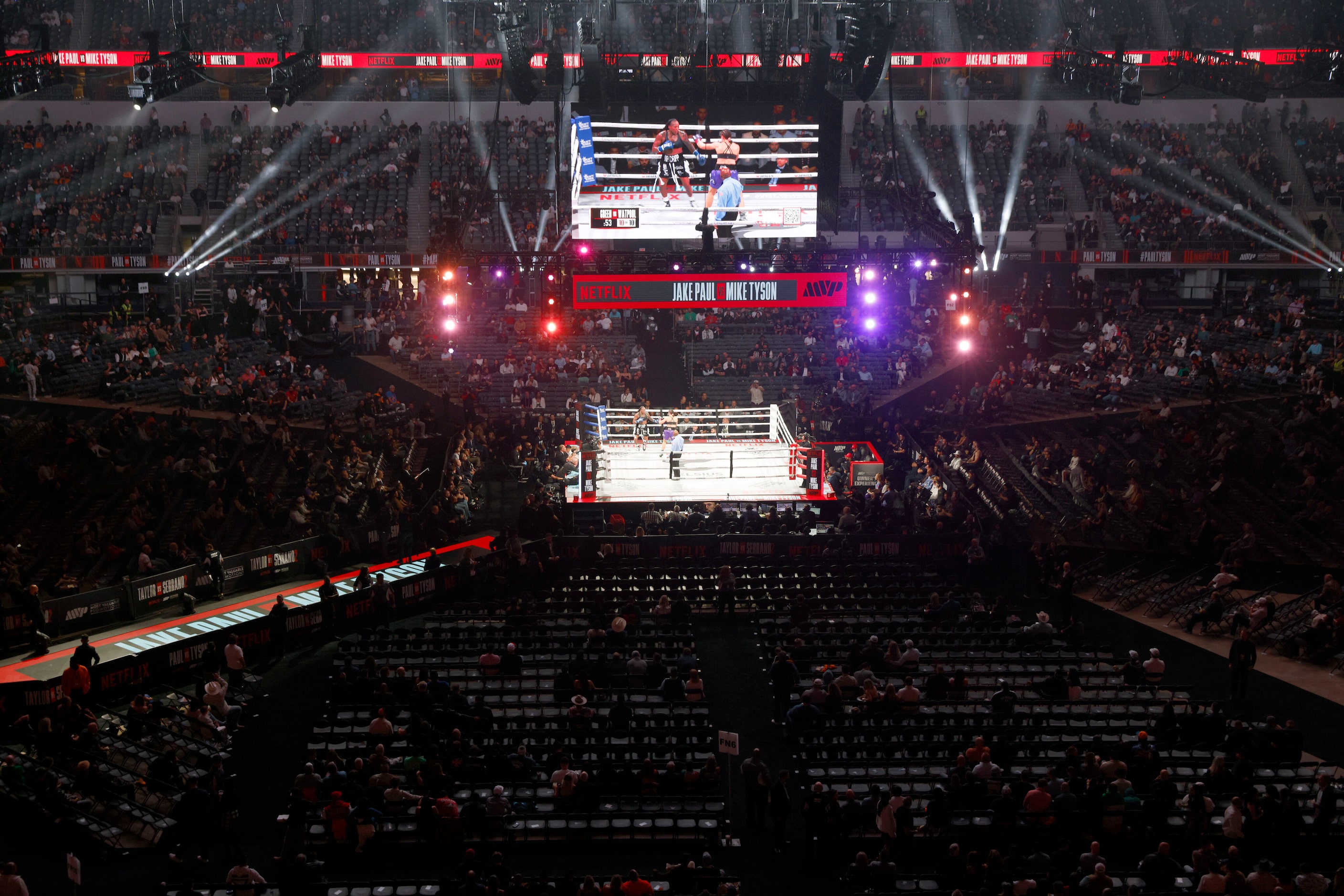 Fans watch a super middleweight boxing match between Melinda Watpool and Shadasia Green for...