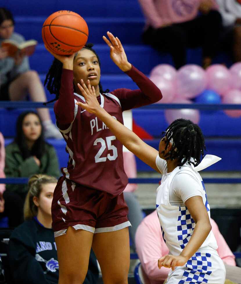 Plano senior Salese Blow (25) attempts a three-point shot over Plano West guard Zaviyana...
