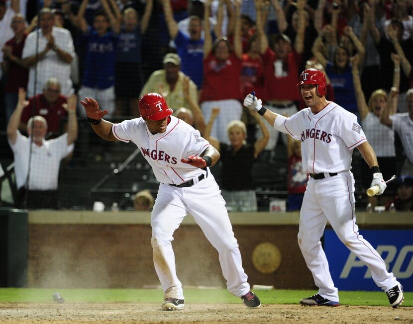 Texas Rangers third baseman Adrian Beltre (29) and first baseman Michael Young (10)...