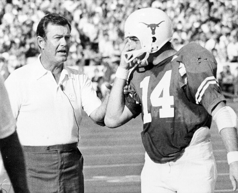 Texas coach Darrell Royal and his quarterback Eddie Phillips check signals during their...