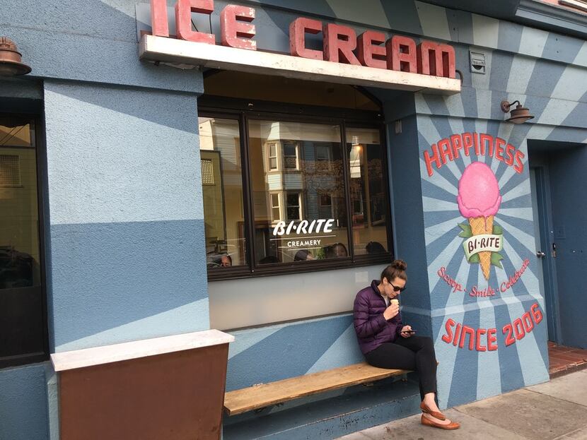 A customer enjoys her ice cream at Bi-Rite Creamery on 18th Street in San Francisco's...