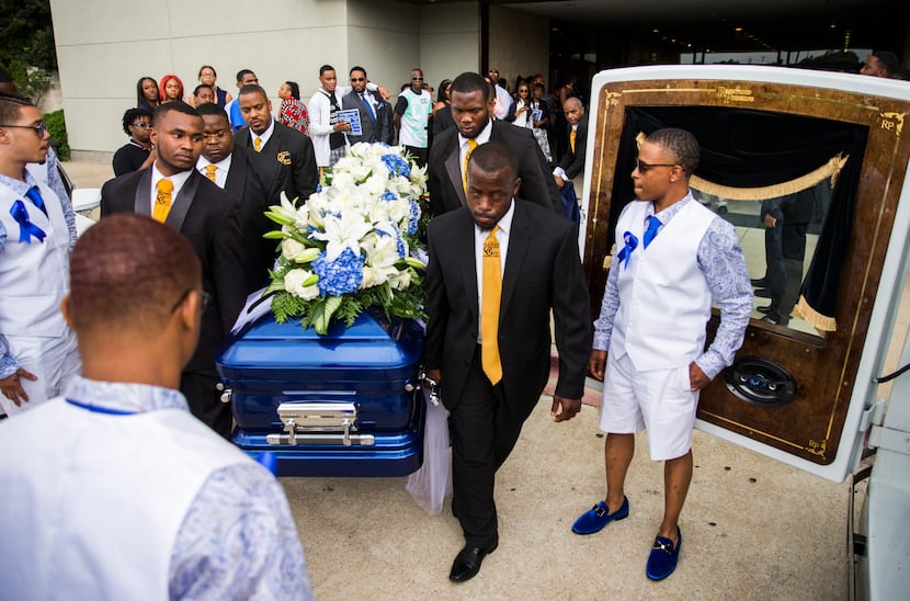 Pallbearers carry the casket of Muhlaysia Booker to a hearse Tuesday after a memorial...