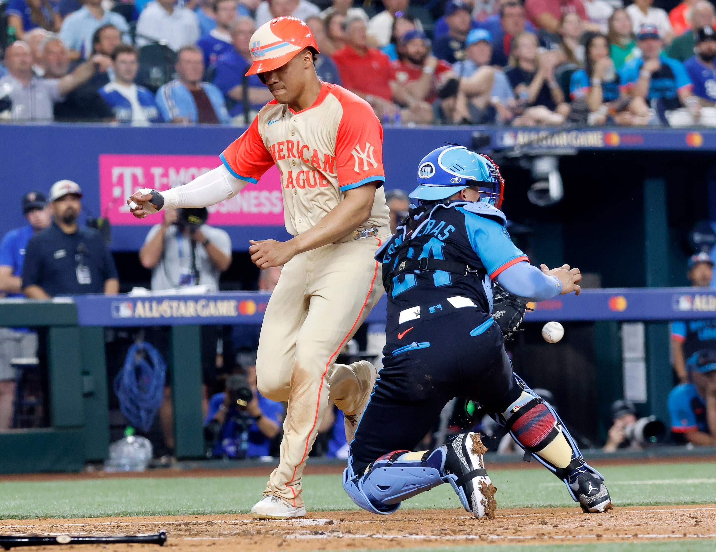 American League's Juan Soto, of the New York Yankees, scores ahead of the throw to National...