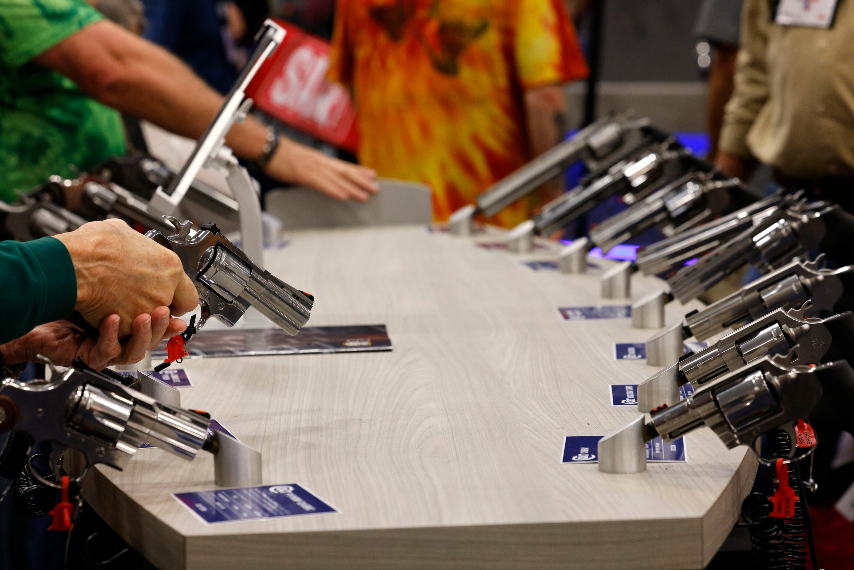 People check the products at the booth of Colt during 2024 NRA Annual Meetings & Exhibits at...