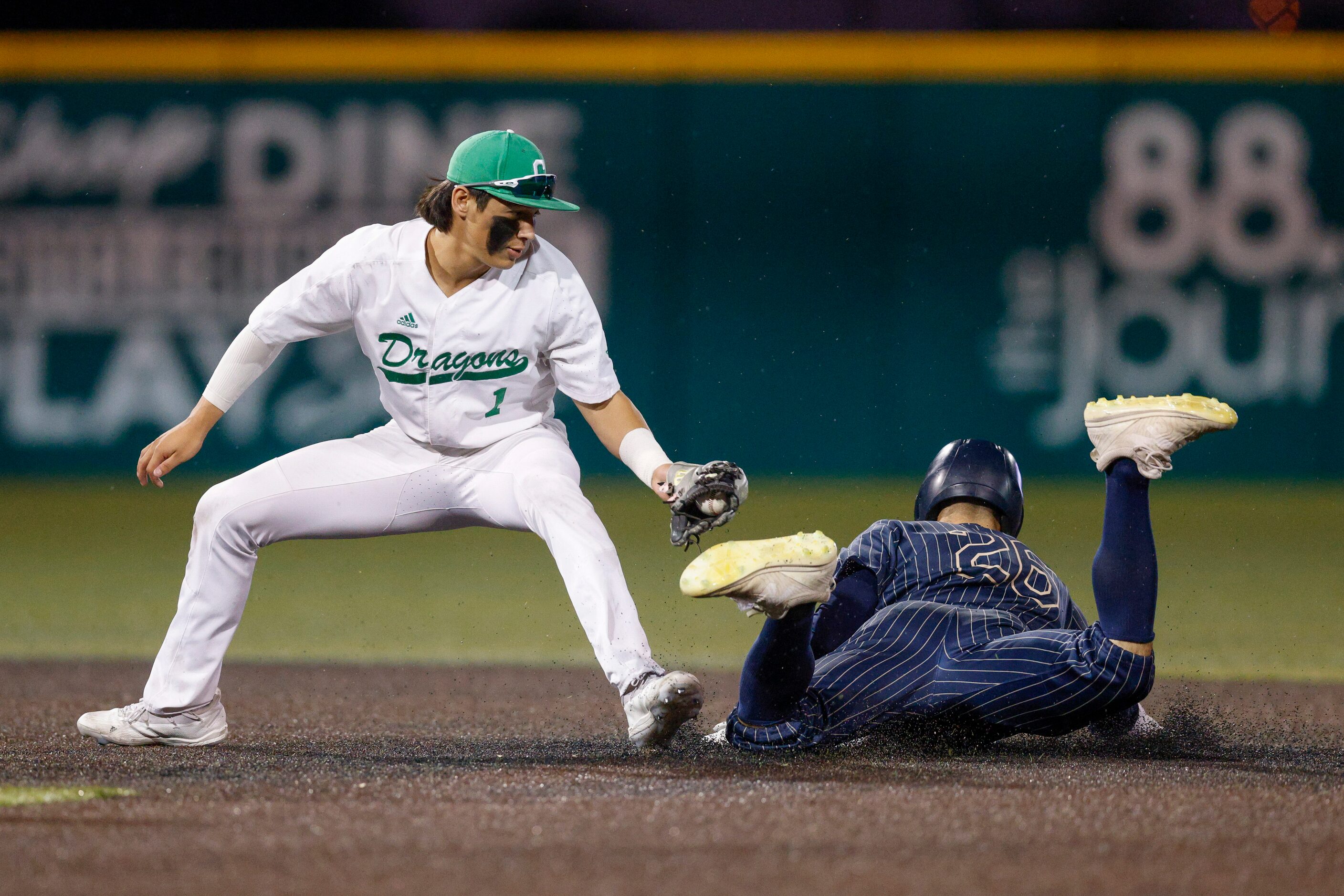 Keller left fielder Jacob Sullens (26) slides under the tag of Southlake Carroll shortstop...