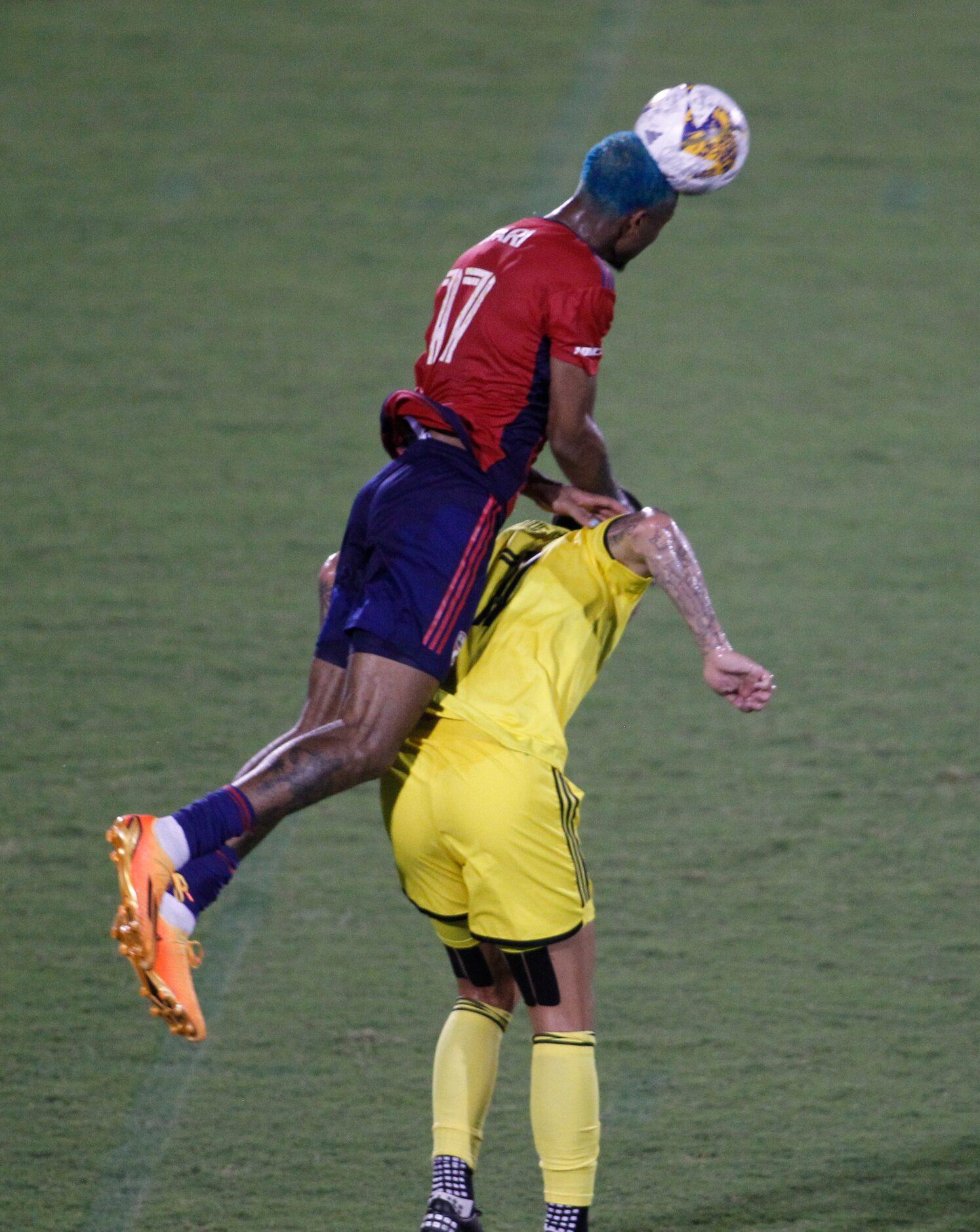 FC Dallas defender Nkosi Safari (17) skies to head the ball to a teammate over the defense...