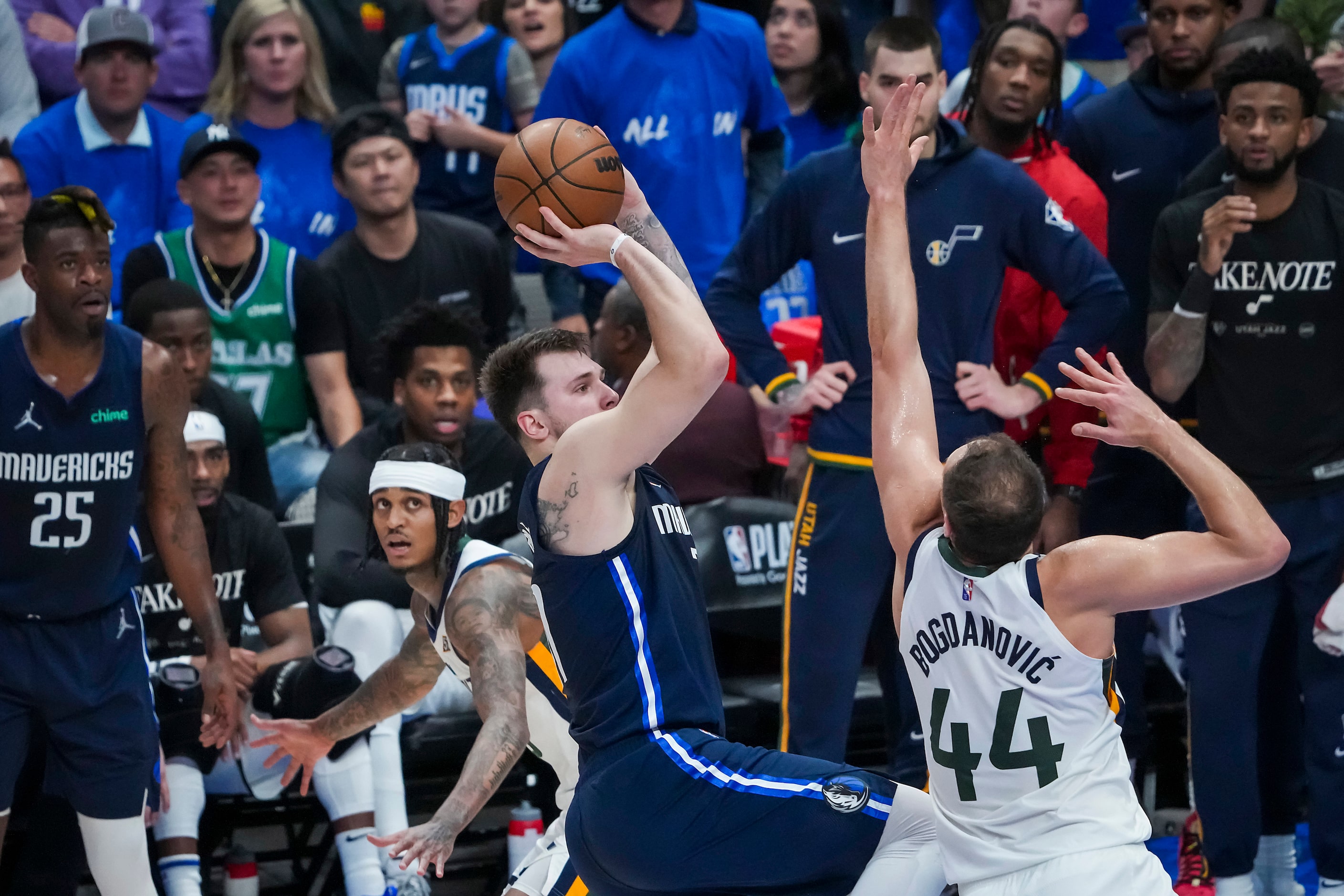 Dallas Mavericks guard Luka Doncic (77) scores over Utah Jazz forward Bojan Bogdanovic (44)...