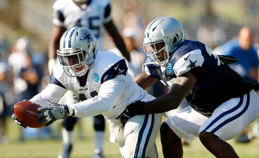 Dallas Cowboys fullback Keith Smith (41) reaches for more yardage as he is tackled from...