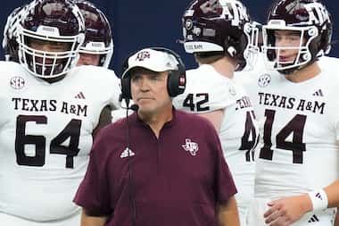 Texas A&M head coach Jimbo Fisher looks on from the sidelines with offensive lineman Layden...